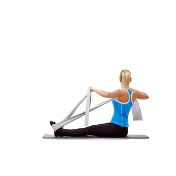 Wellness, resistance band and woman doing exercise in studio for health, fitness and bodycare. Sport, yoga mat and young female person from Australia with arms workout or training by white background.
