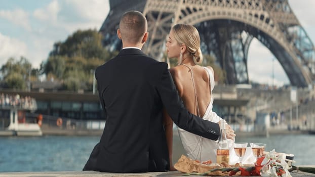 Elegant couple on date in Paris. Action. Luxurious couple on date with view of Paris tower. Eiffel Tower with beloved couple on sunny summer day.