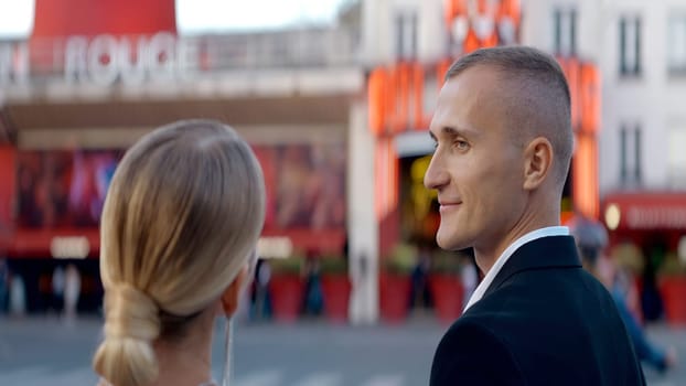 Walking cute couple. Action. A beautiful woman on the street looks at her cute adult partner. High quality 4k footage