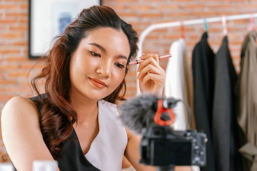 Woman influencer shoot live streaming vlog video review makeup uttermost social media or blog. Happy young girl with cosmetics studio lighting for marketing recording session broadcasting online.