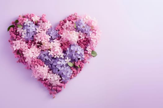 Multicolored flowers are laid out in the shape of a heart on a lilac background. The copy space. Minimalism.