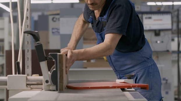 Work at the factory. Creative. Men in special clothes work with wood on special machines. High quality 4k footage