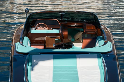 Interior of the luxury motor boat, port of Hercules in Monaco, sunny glare of the sun on the water, powerful boat, glossy surfaces shine in sunny weather. High quality photo