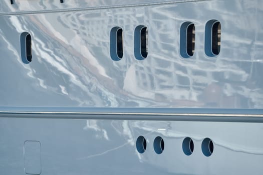 reflections on glossy board of mega boat, tranquillity in port Hercules, windows of moored boat at sunny day, Monaco, Monte-Carlo. High quality photo