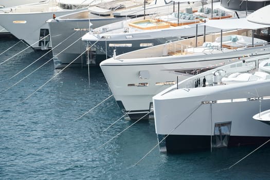 Few huge luxury yachts at the famous motorboat exhibition in the principality of Monaco, Monte Carlo, the most expensive boats for the richest people. High quality photo