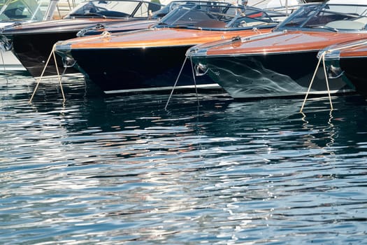 Few luxury retro motor boats in row at the famous motorboat exhibition in the principality of Monaco, Monte Carlo, the most expensive boats for the richest people, boats for rich clients. High quality photo