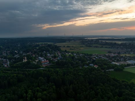 Aerial View of Town at Dawn with Wind Turbines.