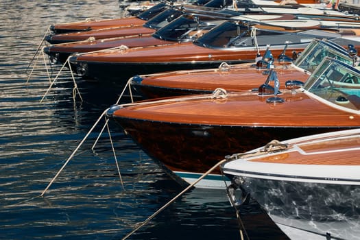 Few luxury retro motor boats in row at the famous motorboat exhibition in the principality of Monaco, Monte Carlo, the most expensive boats for the richest people, boats for rich clients. High quality photo