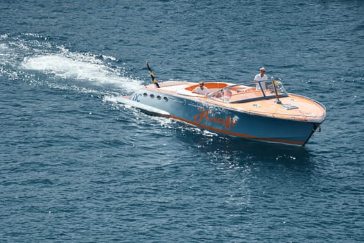 Monaco, Monte Carlo, 28 September 2022 - a boat with guests of yacht brokers departs from the shore in the largest fair exhibition in the world yacht show MYS, port Hercules, rich clients, sunny. High quality photo