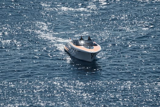 Monaco, Monte Carlo, 28 September 2022 - a boat with guests of yacht brokers departs from the shore in the largest fair exhibition in the world yacht show MYS, port Hercules, rich clients, sunny. High quality photo