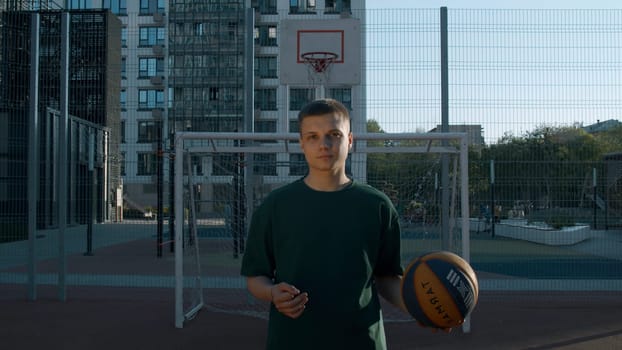 A handsome male athlete. Media. A man standing on a volleyball court with a ball. High quality 4k footage
