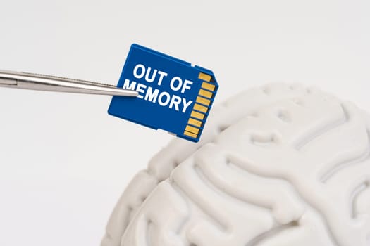 A man inserts a memory card into his brain with the inscription - Out Of Memory. Medicine and technology concept.