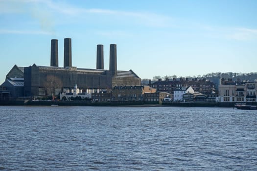 London, United Kingdom - February 03, 2019: South side of river Thames panorama in Greenwich borough, with Trinity Hospital building on left, photographed sunny spring morning