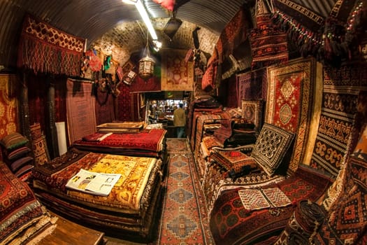 London, United Kingdom - April 01, 2007: Extreme wide angle (fisheye) photo  - oriental rugs and carpets on display at one of Camden Lock stalls, famous flea market in UK capital.