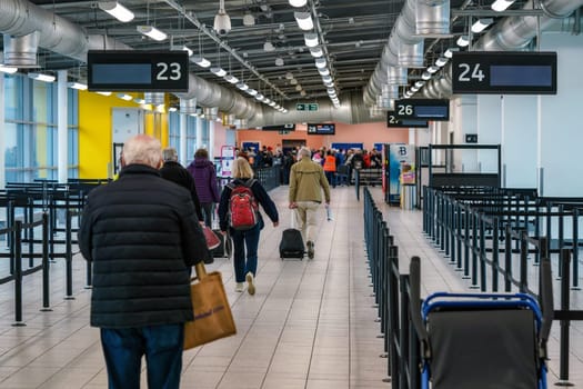 London, United Kingdom - February 05, 2019: Passengers walking in departure hall building to gate desk for their flight, at Luton Airport. LTN is 5th busiest in United Kingdom.