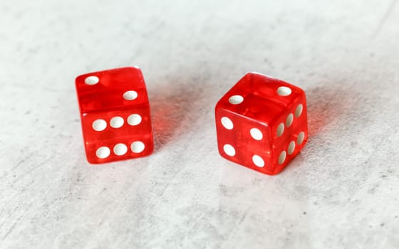 Two translucent red craps dices on white board showing Hard Four / Little Joe (double number two)