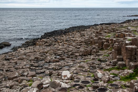 Hexagonal stone columns formations, sea in background, at Giant's causeway, Northern Ireland