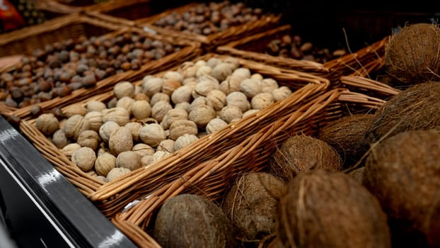 Supermarket Shelves Are Filled With Nuts And Coconuts, And Colorful Pumpkins Are Also Displayed
