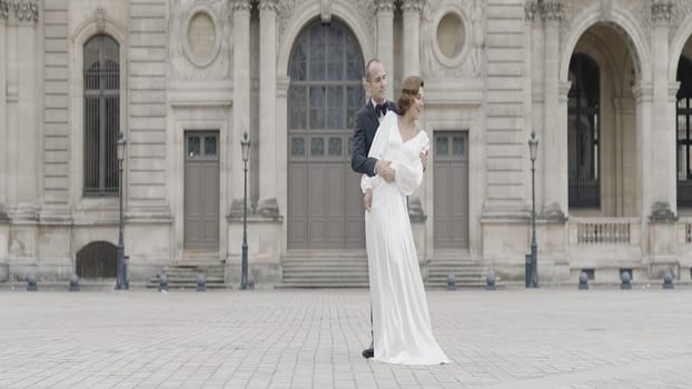 A tall couple in suits posing in the fresh air. Action.A date where people dance and hug in the square. High quality 4k footage