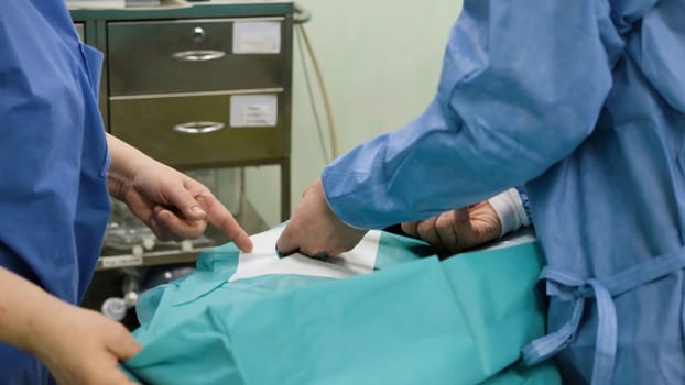 A team of surgeons in operating room during procedure. Creative. Medical technologies, concept of sickness