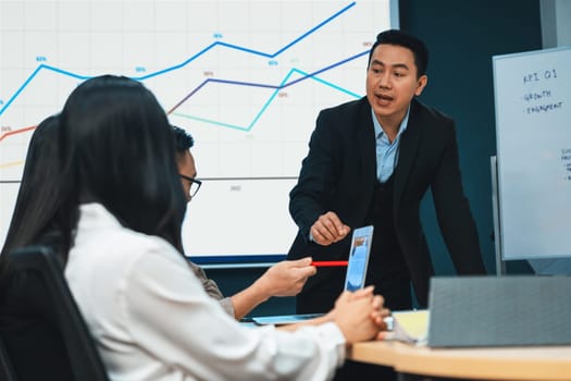 Successful businessman presenting his financial plan and data analyst with confident. group of executive editor focusing on his performance intentionally. Office Conference room meeting. Intellectual.