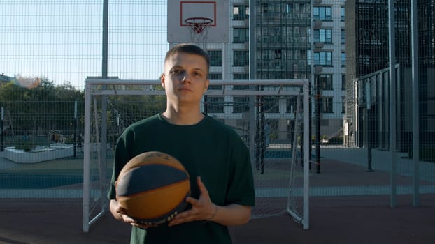 A handsome male athlete. Media. A man standing on a volleyball court with a ball. High quality 4k footage