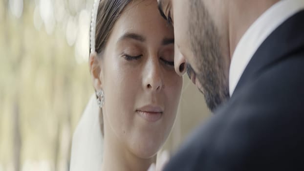 A couple enjoying each other. Action. An adult man with stubble and a cute woman with makeup are bumping into each other's face. High quality 4k footage