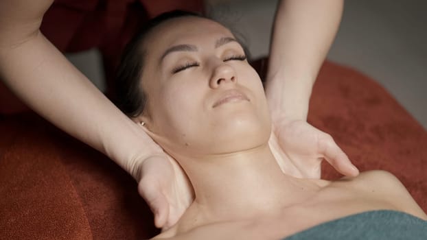Full body massage.Action.A young girl who lies and a master who does a full body massage with oil. High quality 4k footage