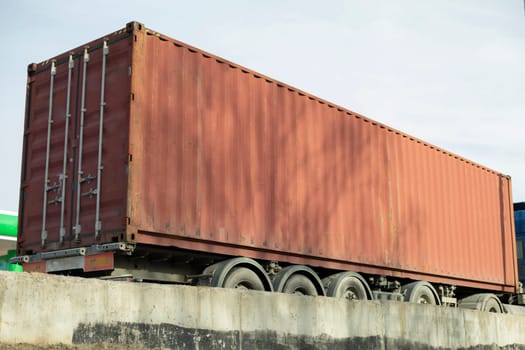 Container on truck. Transportation of goods by road. Large container of red color. Transportation of goods.