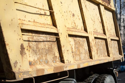 Steel body. Truck parts. Heavy machine. Yellow bodywork. Rust on car.