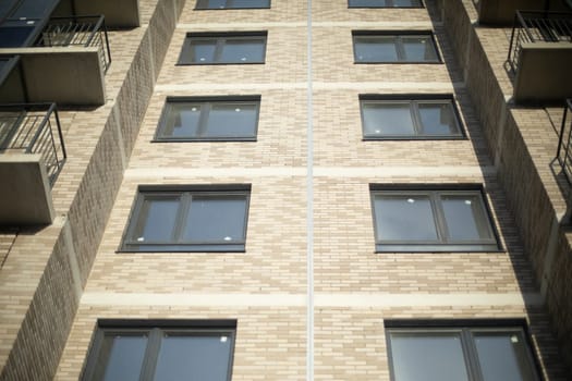 Windows in building. New building in city. Balconies and windows.