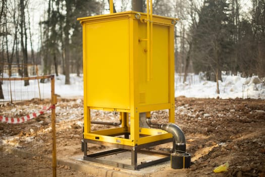 Gas equipment on street. Yellow technical structure. Urban infrastructure. Gas supply.