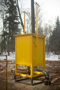 Gas equipment on street. Yellow technical structure. Urban infrastructure. Gas supply.