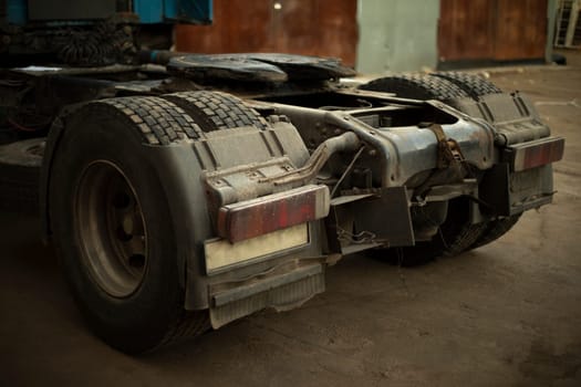 Rear wheels of trucks. Truck in parking lot. Machine without trailer. Truck parts.