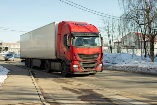 Truck is driving down highway. Transportation of goods by transport. Large car cab. Transportation of goods.