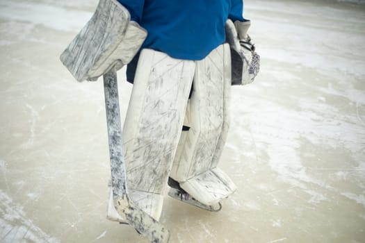 Hockey player, goalkeeper at stadium. Winter sport. Goalie on ice. Sposrtsman in winter.