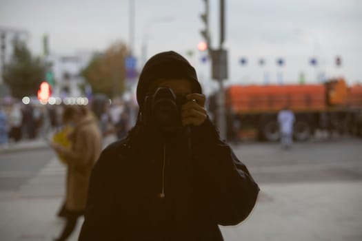 Photographer takes pictures of himself. Reflection in mirror. Reflection capture. Person with photo camera.