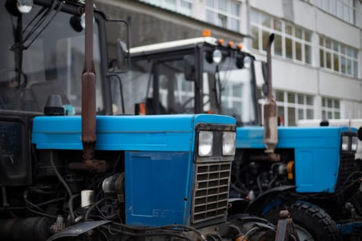 Blue tractor. Industrial engineering. Agricultural transport. Diesel engine.