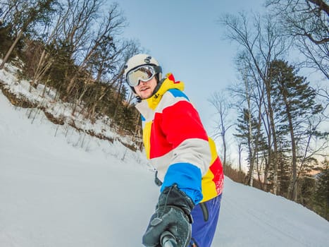 A daring man conquers snowy slopes with style, showcasing skill and thrill as he maneuvers on a snowboard, capturing the essence of winter adventure.