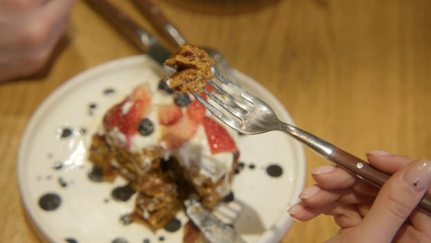 Close-up of couple on date with delicious dishes. Stock footage. Delicious dishes and desserts in restaurant for evening dinner. Couple have desserts at restaurant in evening.