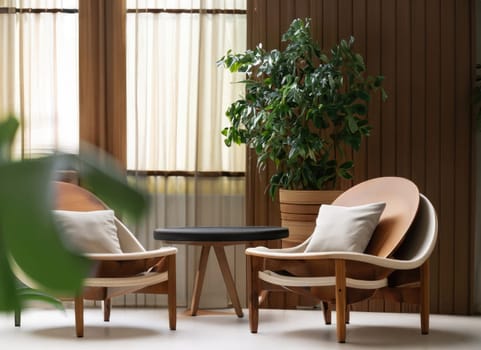  Two barrel chairs and round wooden coffee table against window near paneling wall