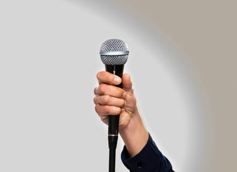 hands holding microphone on stand