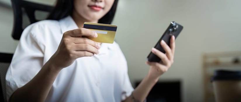 Woman on desk with smartphone, credit card and ecommerce payment for online shopping at home. digital bank app and sale on store website with internet banking.