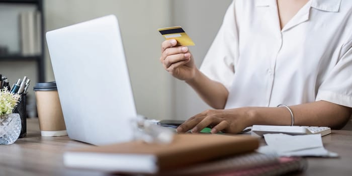 Woman on desk with laptop, credit card and ecommerce payment for online shopping at home. digital bank app and sale on store website with internet banking.