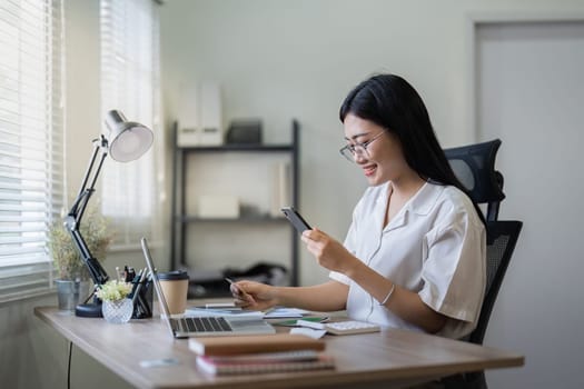 Woman on desk with smartphone, credit card and ecommerce payment for online shopping at home. Happy female customer, digital bank app and sale on store website with internet banking.