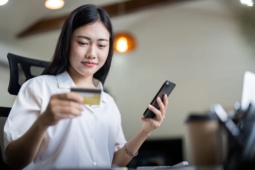 Woman on desk with smartphone, credit card and ecommerce payment for online shopping at home. Happy female customer, digital bank app and sale on store website with internet banking.