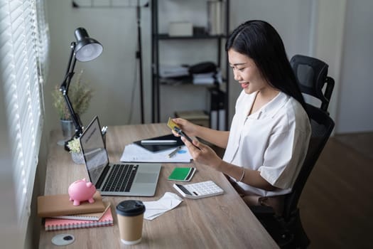Woman on desk with smartphone, credit card and ecommerce payment for online shopping at home. Happy female customer, digital bank app and sale on store website with internet banking.