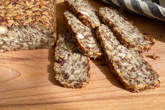 Homemade glutenfree bread with hazelnut and flax seeds on a wooden Board background close-up. Food for diet and health. Healthy almond bread, Keto, ketogenic diet, paleo, low carb fat