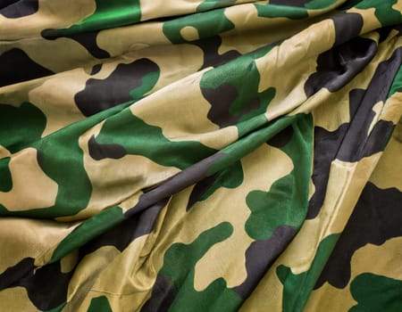 Camouflage texture in a military style on silk fabric. Hight realistics silk.