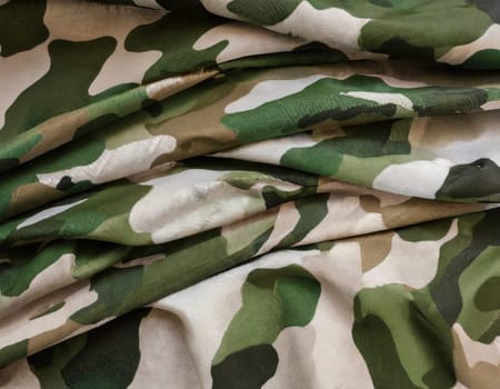 Camouflage texture in a military style on silk fabric. Hight realistics silk.